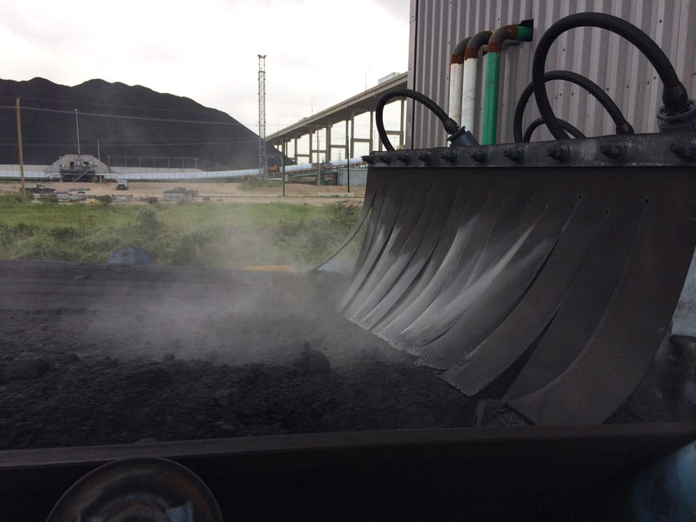 Dust suppression on conveyor transfer at marine and rail terminal